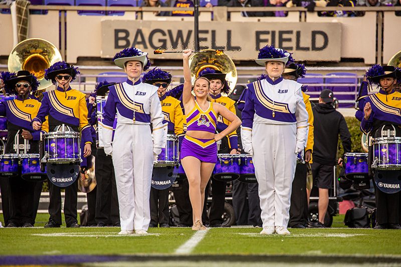ECU Drum Majors take the field with featured twirler