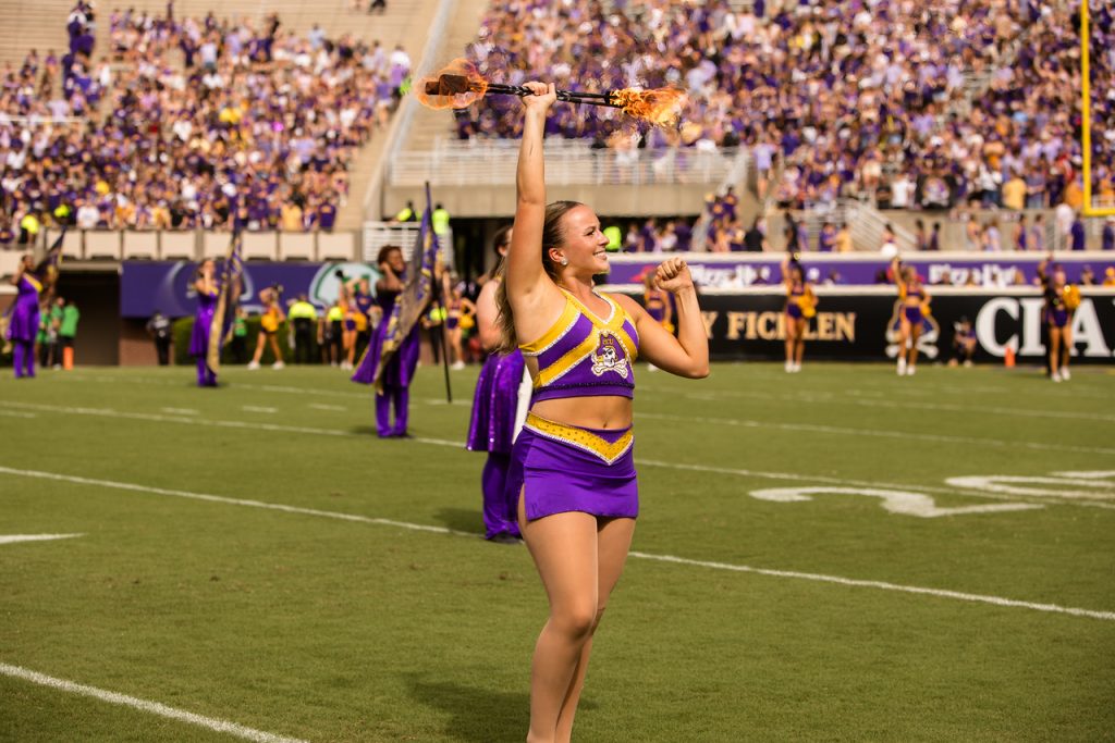 ECU Feature Twirler Kasey Rogers twirling with fire during a pregame show