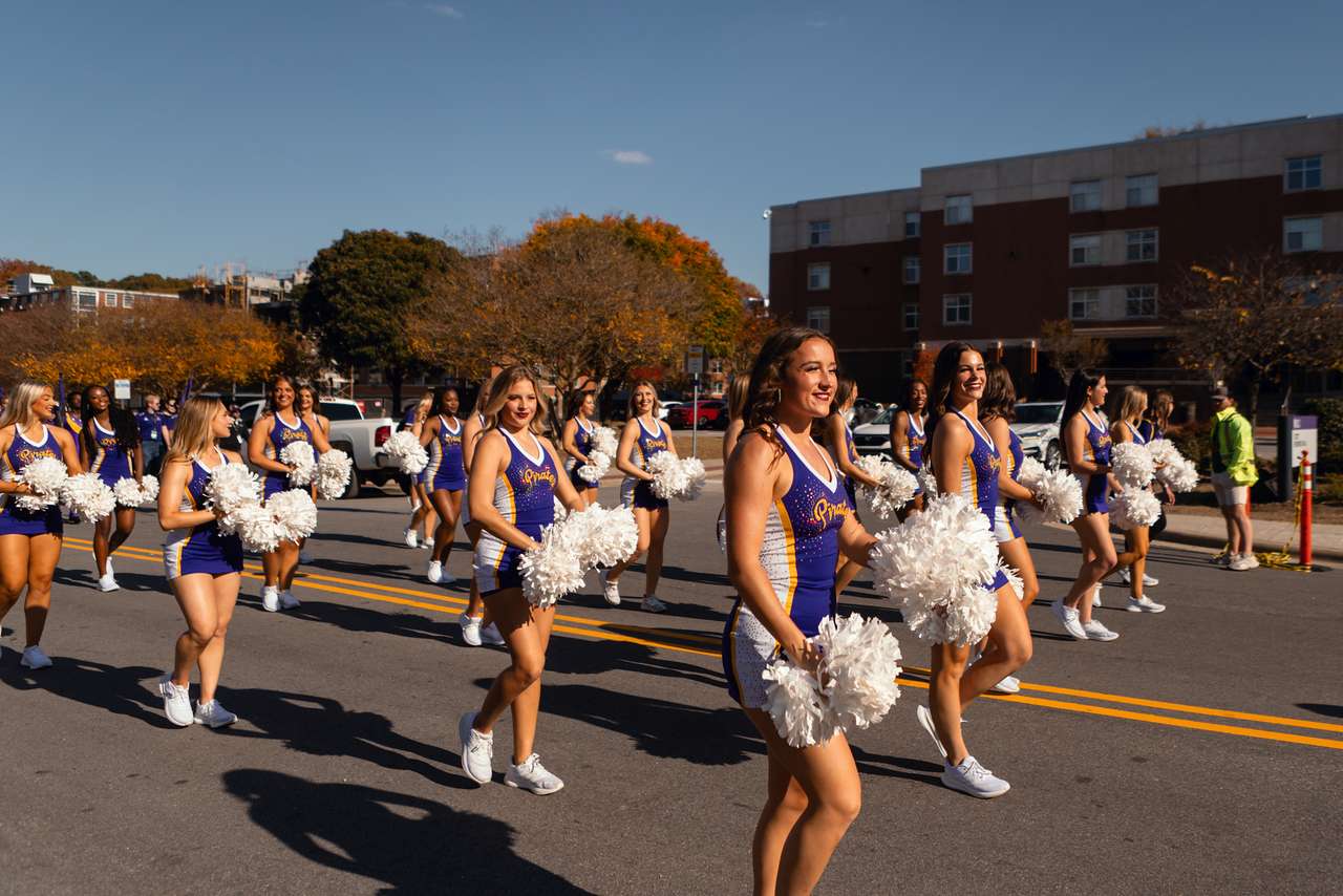 Members of the ECU dance team march in parade with the ECU Marching Pirates