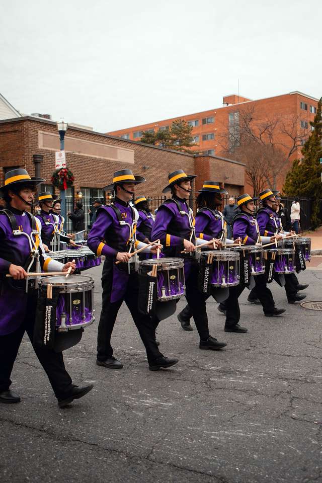 ECU Drumline marches in parade with the ECU Marching Pirates